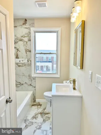 a bathroom with a bathtub sink and a toilet