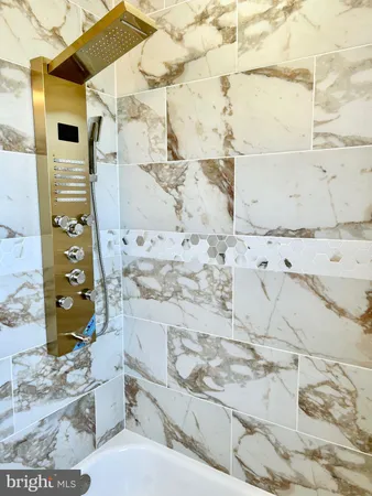 a bathroom with a shower and a sink