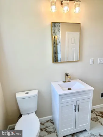 a bathroom with a toilet sink and mirror