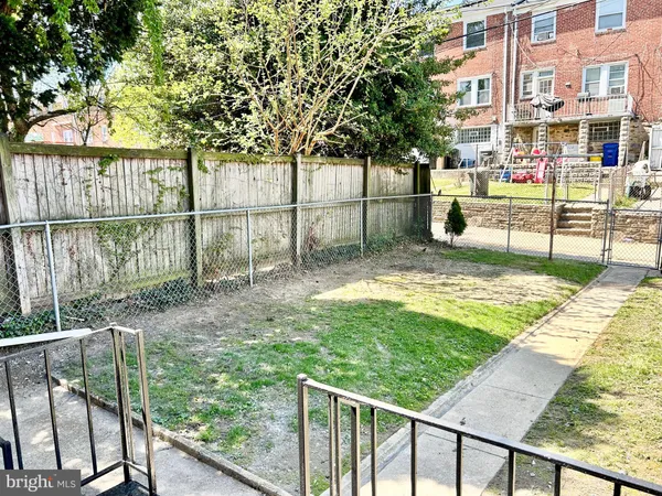 a view of a brick house with a yard