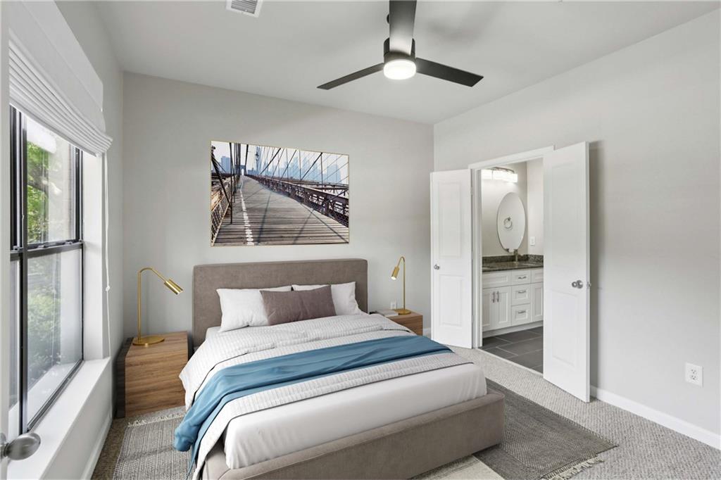 821 Ralph McGill Boulevard Northeast, Unit 2113 Atlanta, GA 30306 - Photo 4 of 29 a bedroom with a large bed and a chandelier