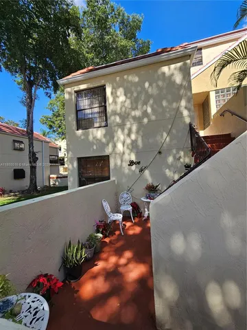 a view of a house with a backyard and a tub