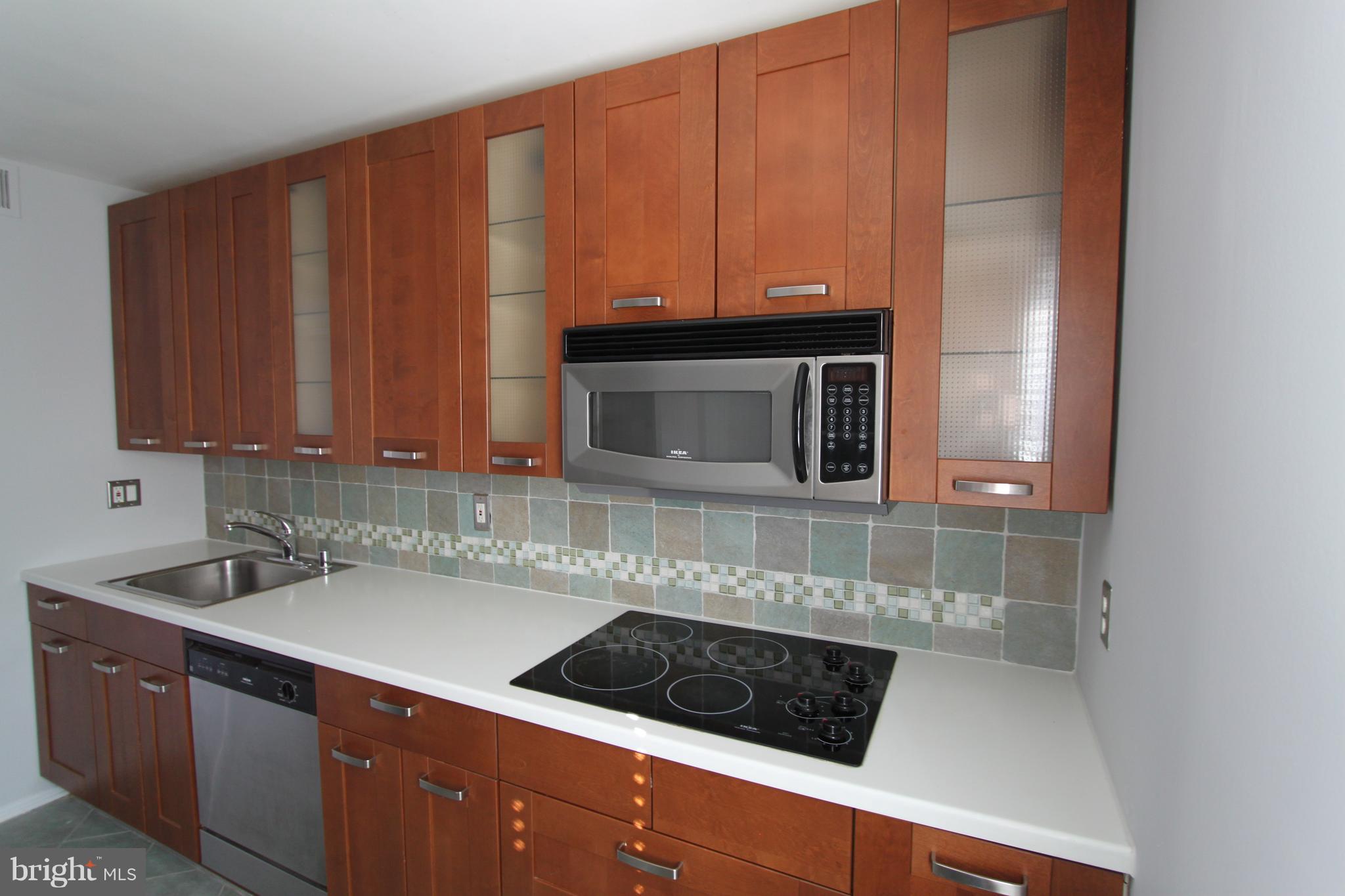 5525 Miles Court Springfield, VA 22151 - Photo 7 of 28 Tile Backsplash, Corian Counters & Cook Top