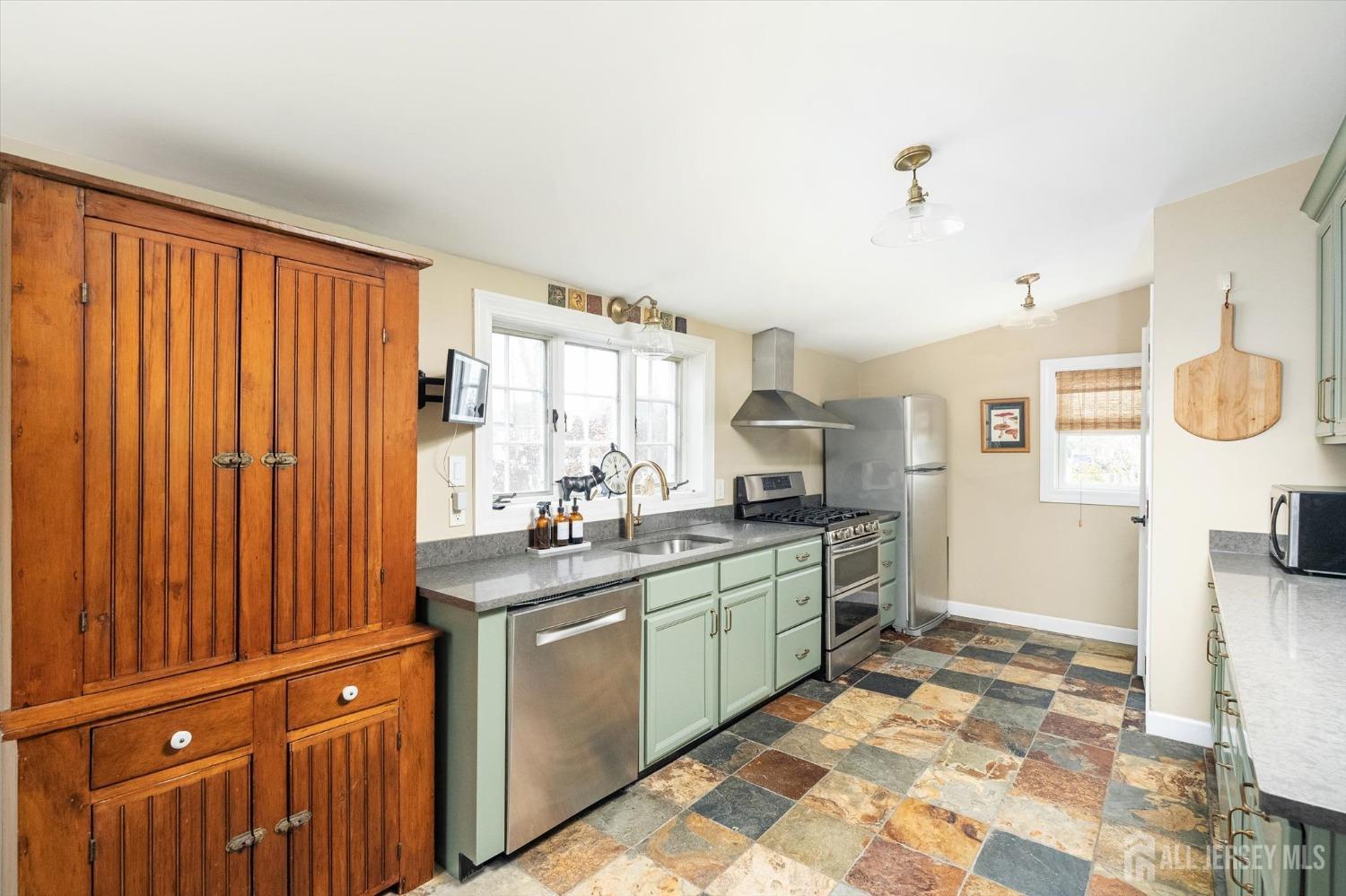 442 Ellisdale Road Chesterfield, NJ 08515 - Photo 13 of 42 a kitchen with a sink a stove cabinets and wooden floor