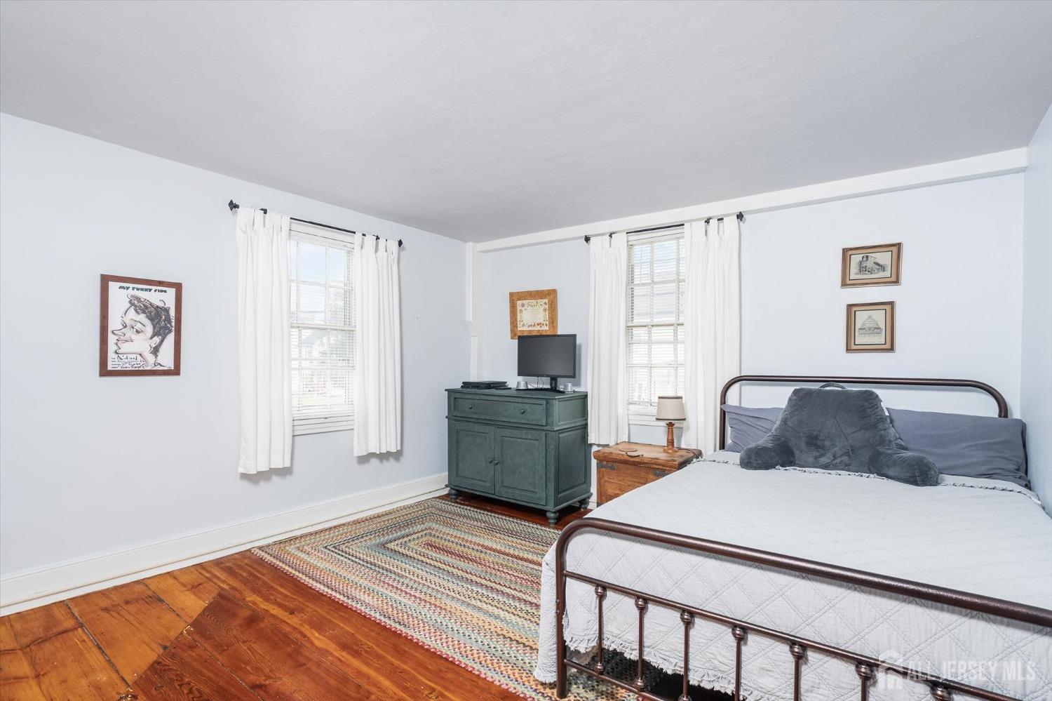 442 Ellisdale Road Chesterfield, NJ 08515 - Photo 20 of 42 a bedroom with a bed and wooden floor