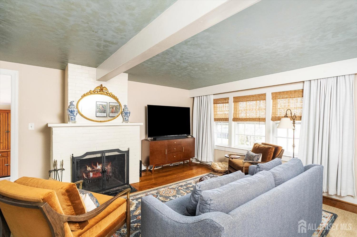 442 Ellisdale Road Chesterfield, NJ 08515 - Photo 9 of 42 a living room with furniture a flat screen tv and a fireplace