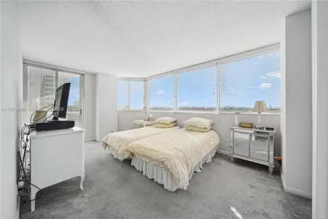 a bed room with furniture and mirror