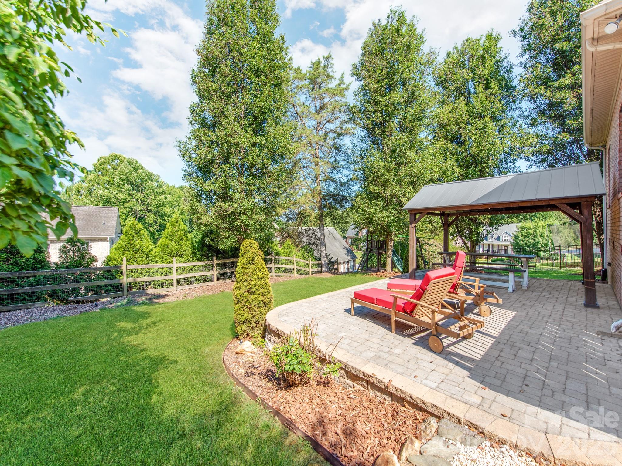 783 Sloan Street Denver, NC 28037 - Photo 34 of 44 an outdoor space with furniture and umbrella