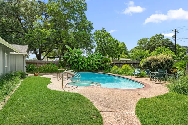a view of a house with swimming pool and sitting area