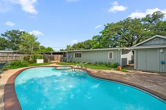 a view of a swimming pool with a patio