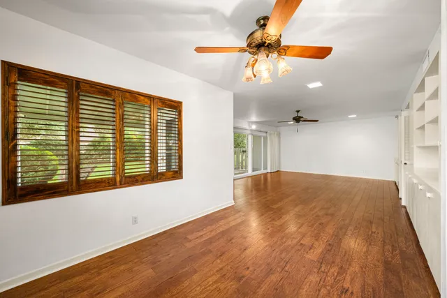 a view of an empty room with wooden floor