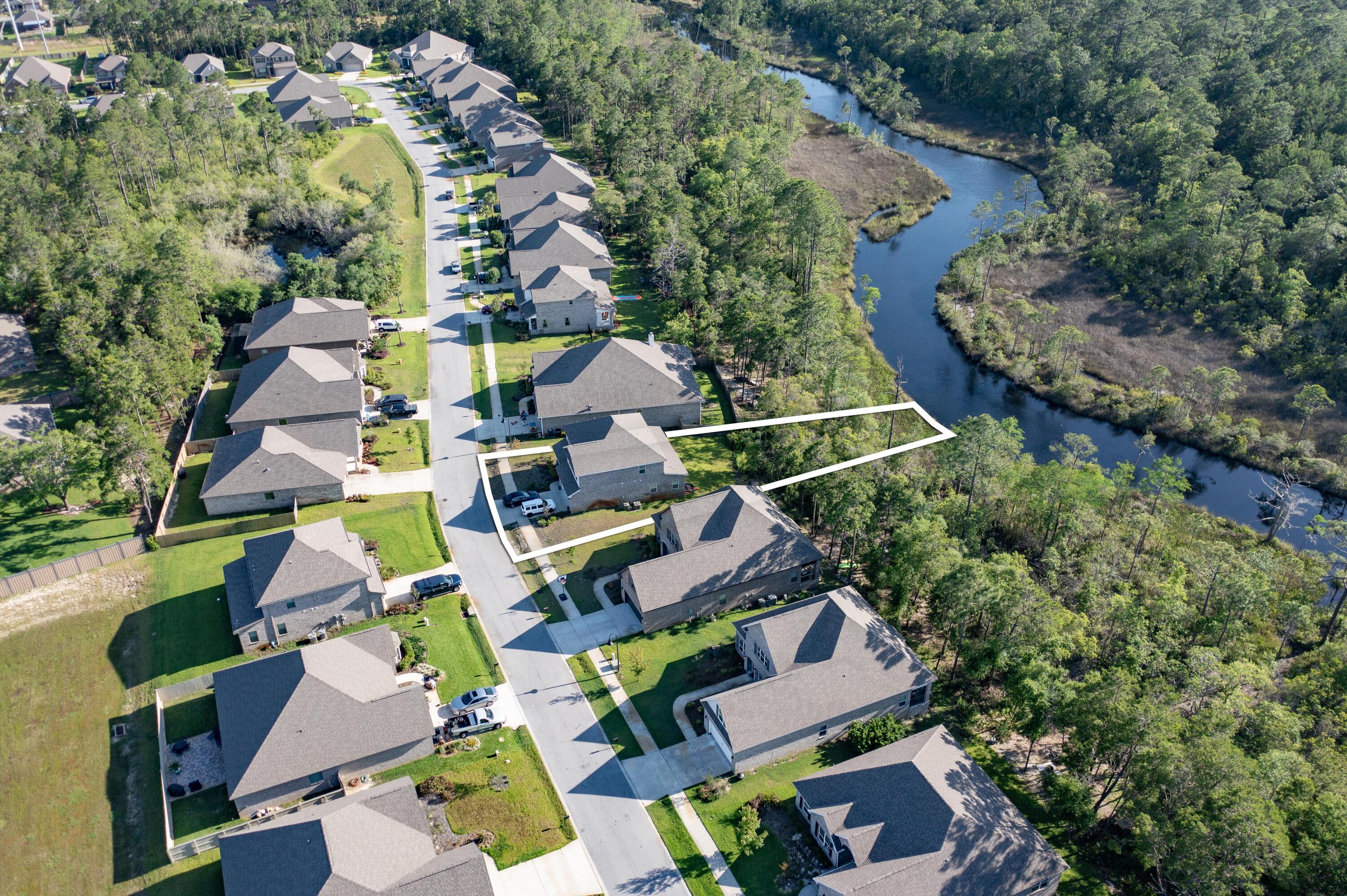 an aerial view of residential house with outdoor space and swimming pool
