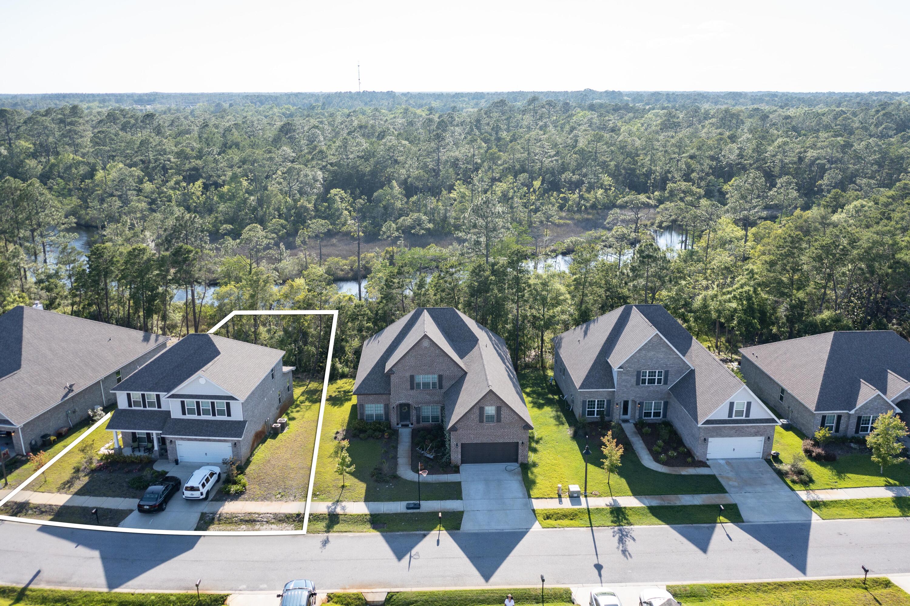 233 Maddox Street Santa Rosa Beach, FL 32459 - Photo 4 of 14 a aerial view of residential houses with yard and swimming pool