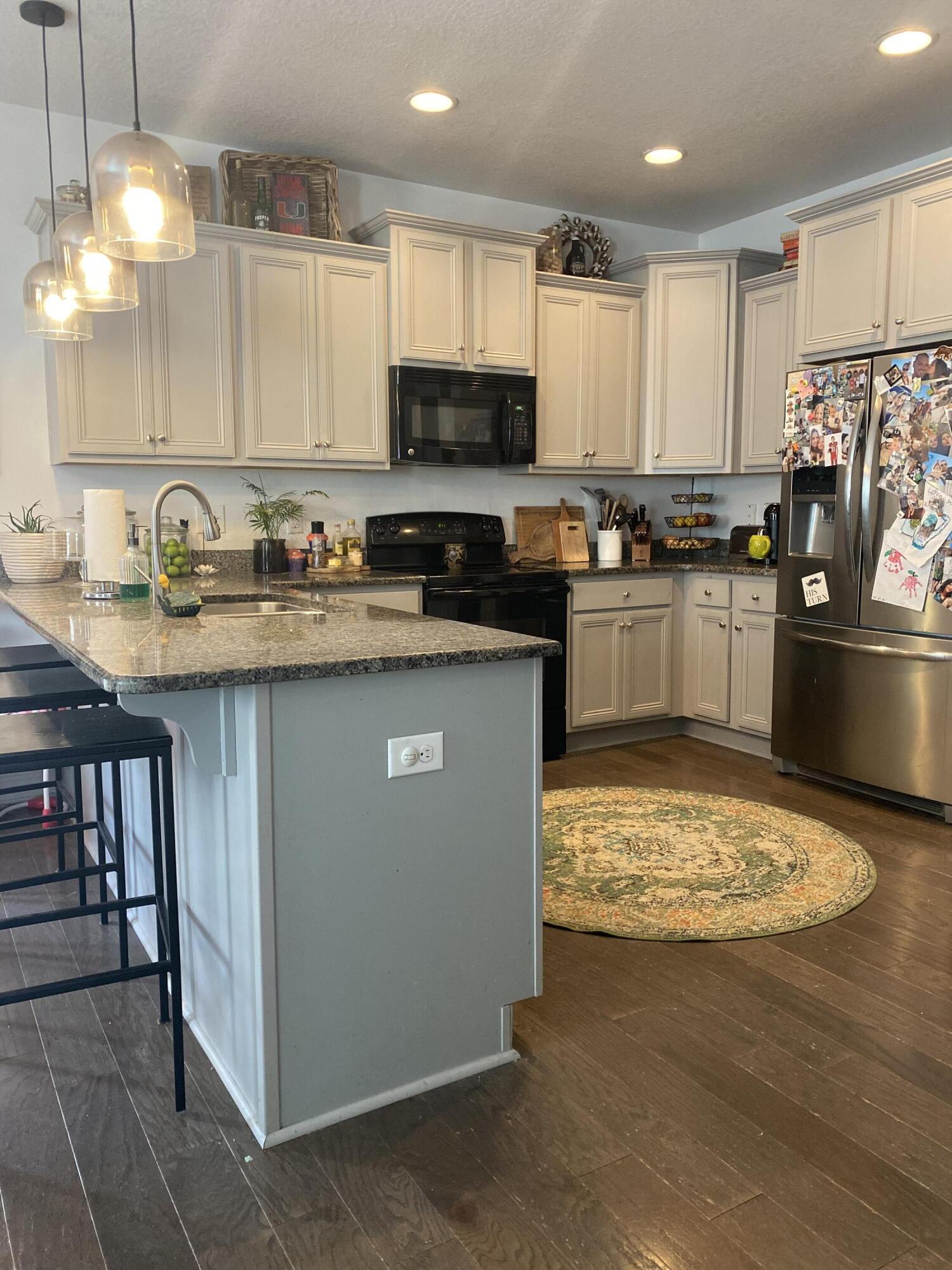 233 Maddox Street Santa Rosa Beach, FL 32459 - Photo 6 of 14 a kitchen with stainless steel appliances granite countertop a sink stove and refrigerator