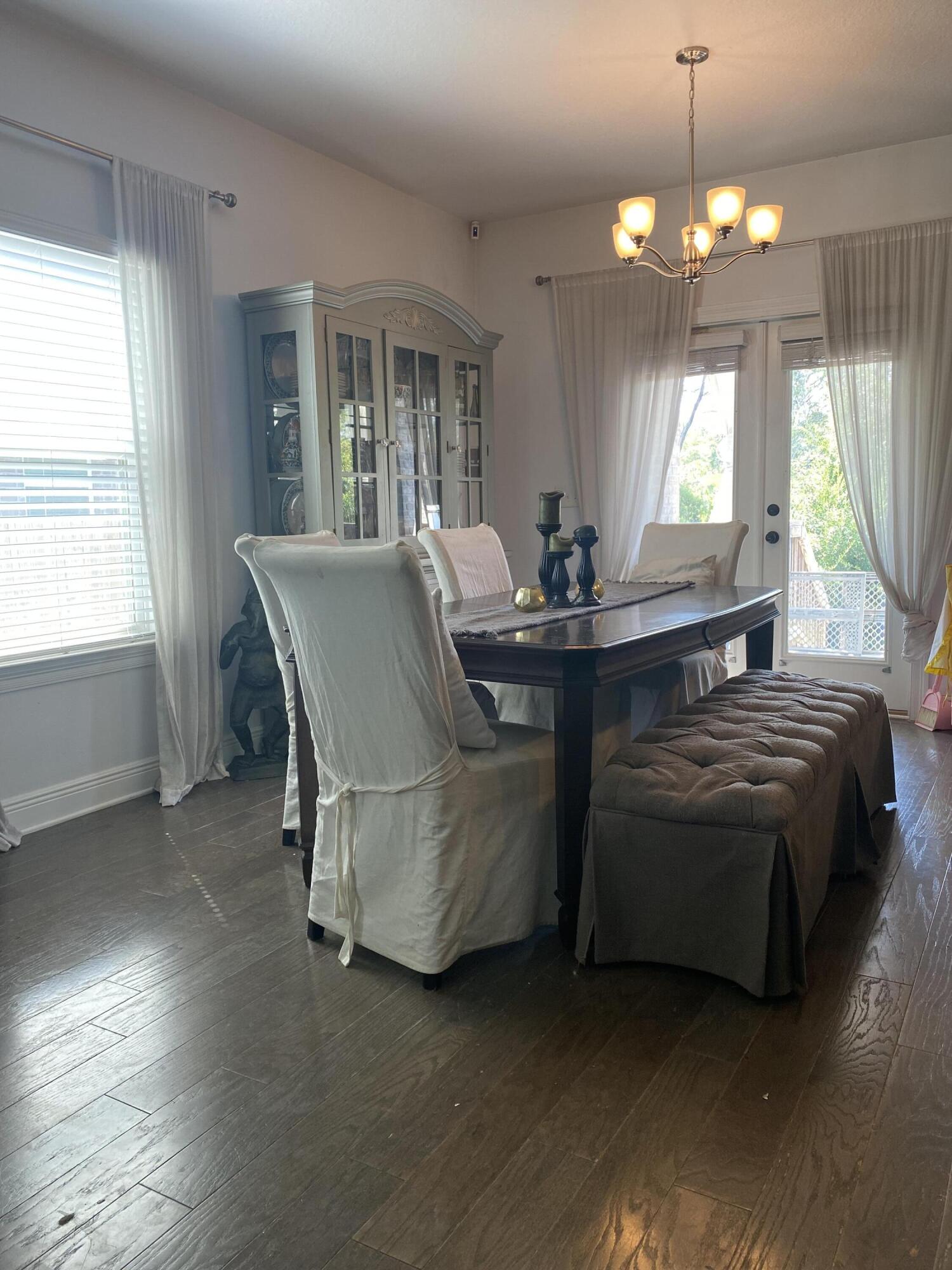 233 Maddox Street Santa Rosa Beach, FL 32459 - Photo 8 of 14 a living room with a bed furniture and a chandelier