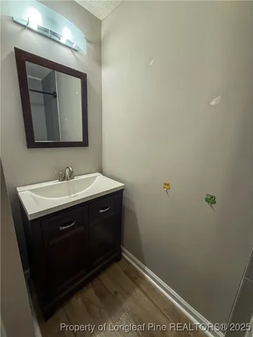 a bathroom with a sink vanity and a mirror