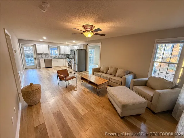 a living room with furniture and a large window