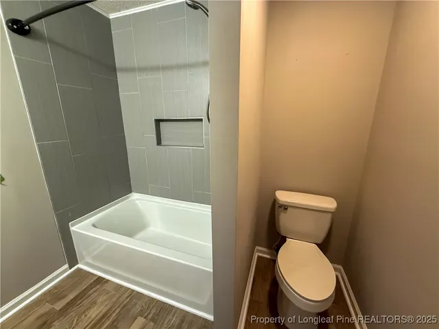 a white toilet sitting next to a bathroom sink
