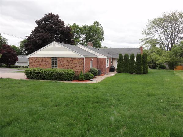 156 Pleasant Street Lexington, MA 02421 - Photo 25 of 28 a view of a house next to a big yard and large trees