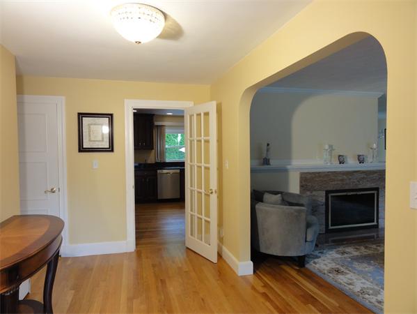156 Pleasant Street Lexington, MA 02421 - Photo 3 of 28 a view of a livingroom with wooden floor and a fireplace
