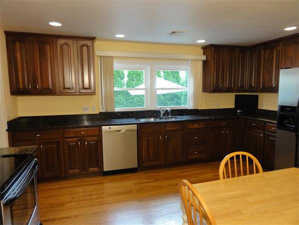 156 Pleasant Street Lexington, MA 02421 - Photo 10 of 28 a kitchen with a sink and wooden cabinets