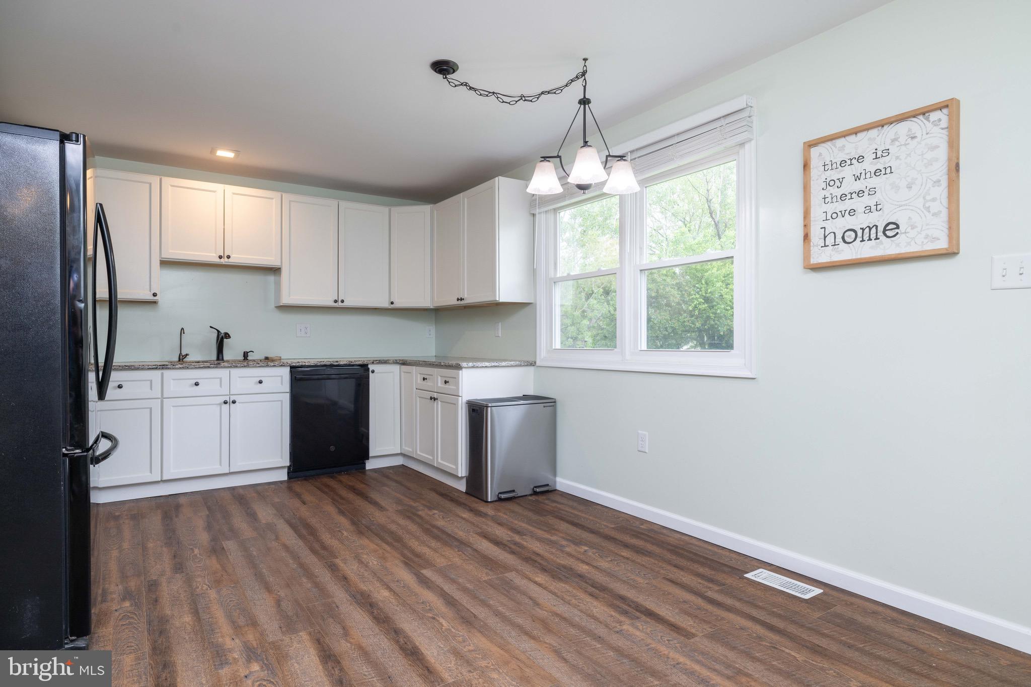 9 Augusta Drive Elkton, MD 21921 - Photo 4 of 21 a kitchen with wooden floors and white cabinets