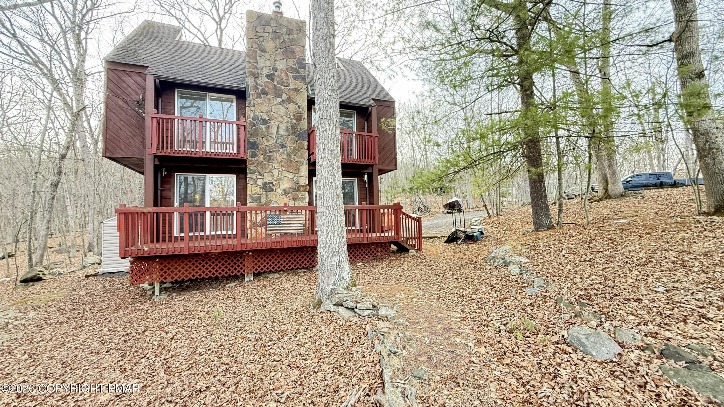a backyard of a house with barbeque oven table and chairs