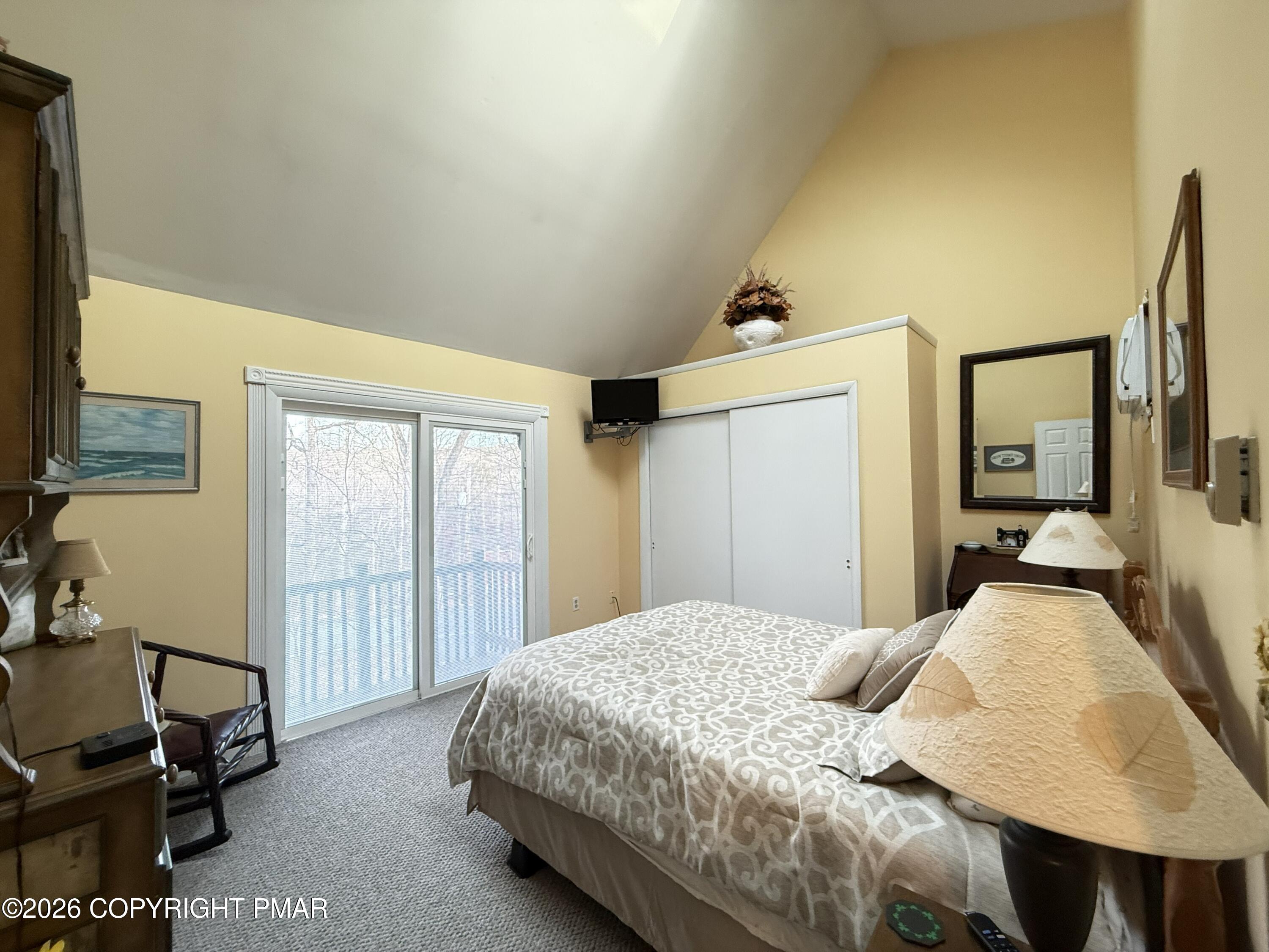 5933 Decker Road Bushkill, PA 18324 - Photo 19 of 51 a bedroom with a bed a mirror on desk and chair