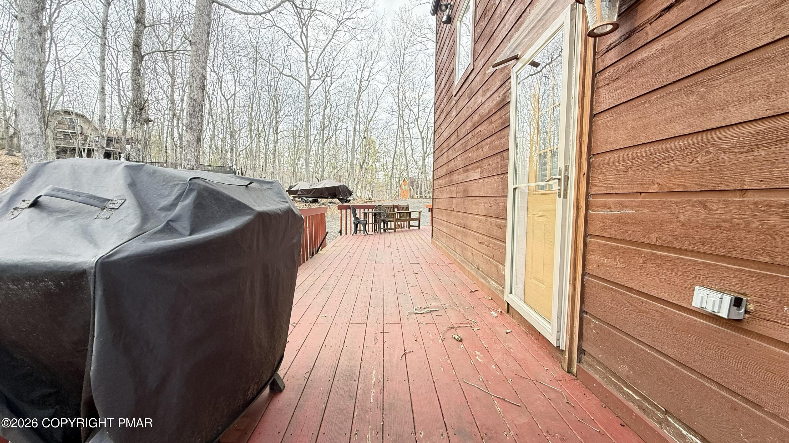 5933 Decker Road Bushkill, PA 18324 - Photo 4 of 51 a balcony with furniture and wooden floor