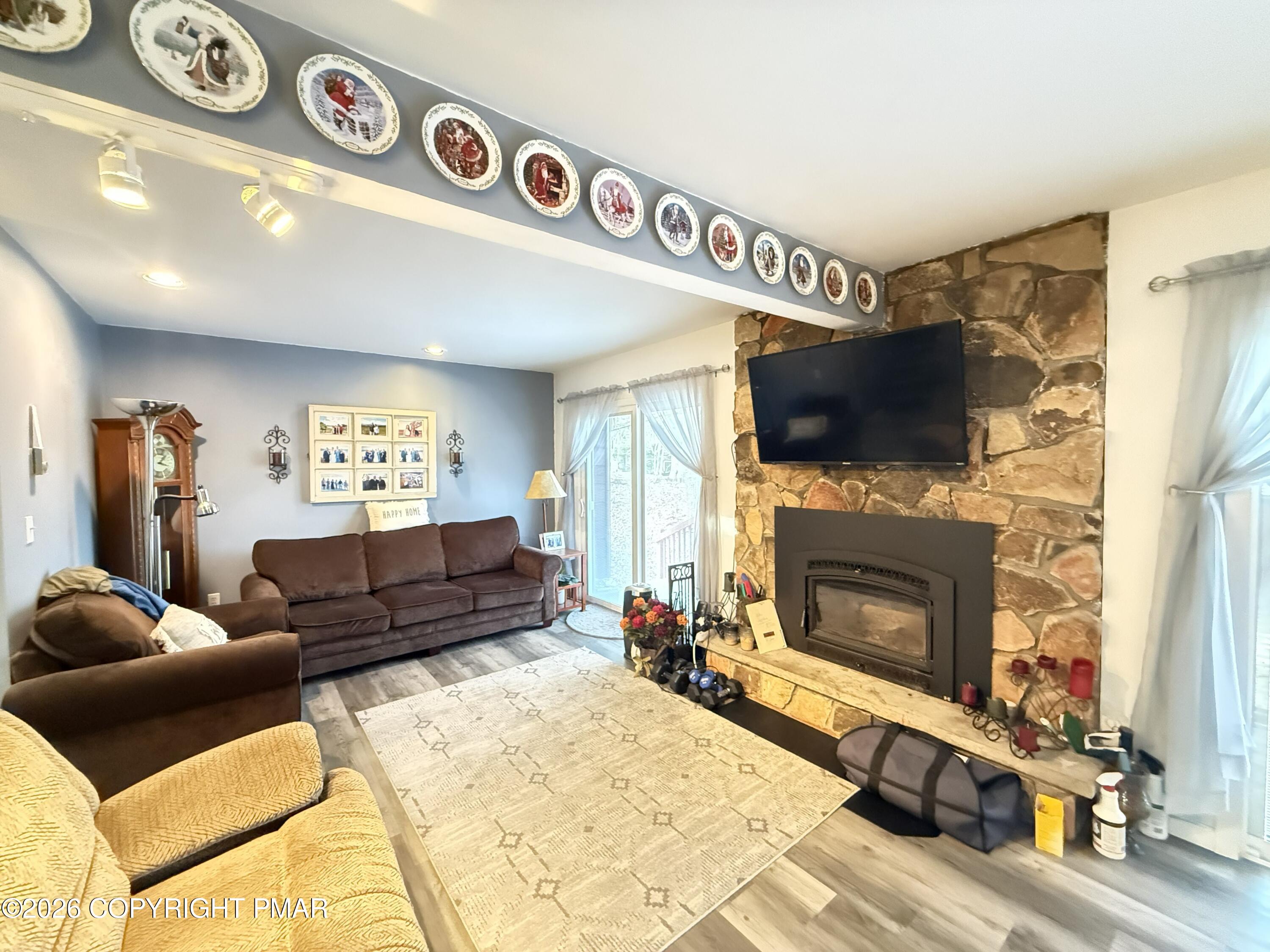 5933 Decker Road Bushkill, PA 18324 - Photo 5 of 51 a living room with furniture a flat screen tv and a fireplace