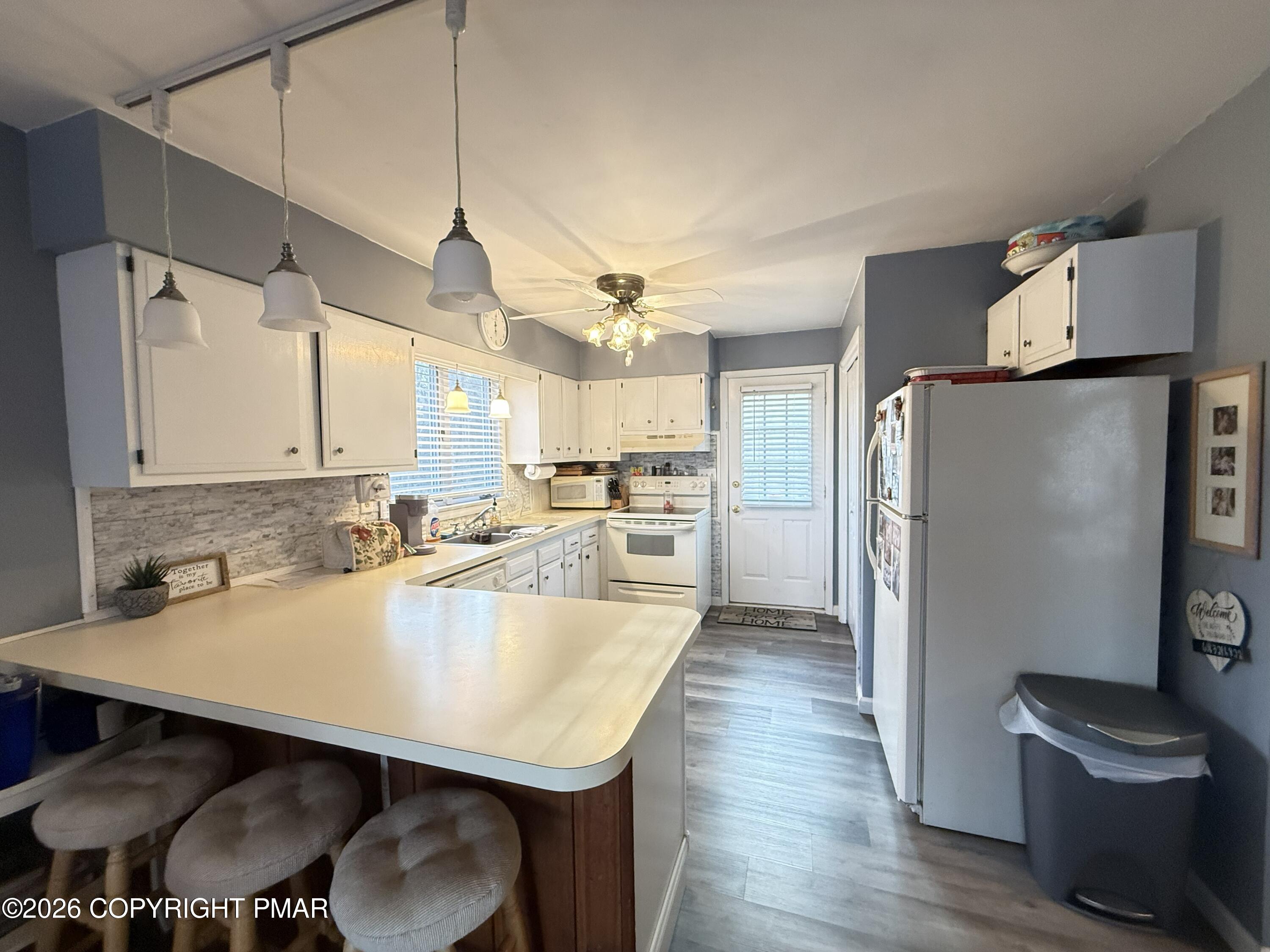 5933 Decker Road Bushkill, PA 18324 - Photo 8 of 51 a kitchen with refrigerator and chairs