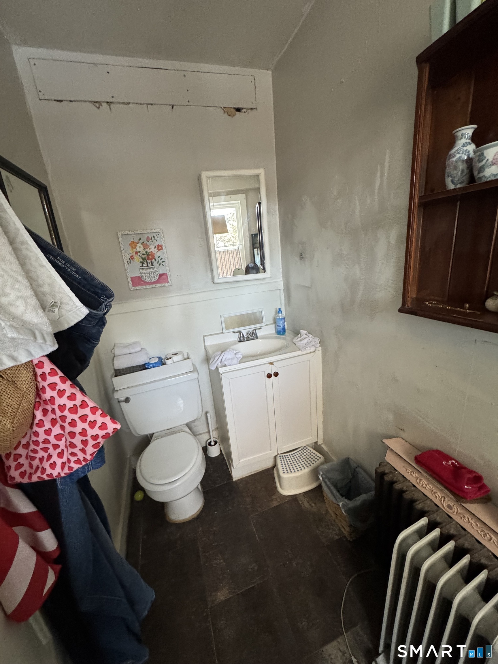 a bathroom with a sink toilet and a mirror