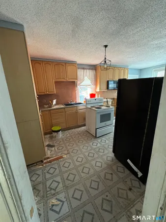 a kitchen with a sink a refrigerator and a stove