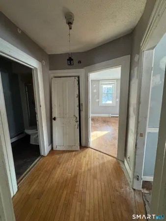 a view of hallway with wooden floor