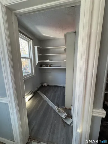 a view of hallway with wooden floor