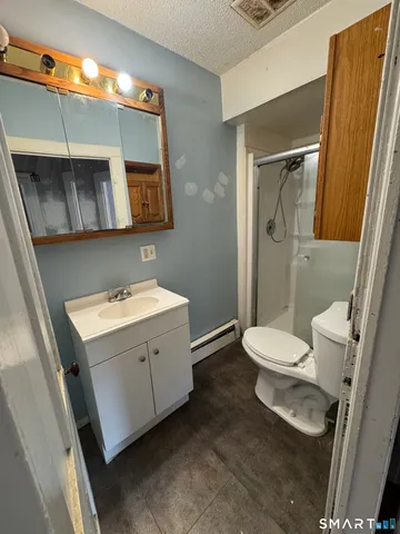 a bed sitting in a room next to a window