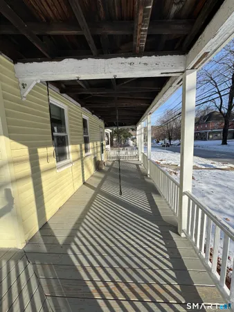 a view of a porch with wooden floor