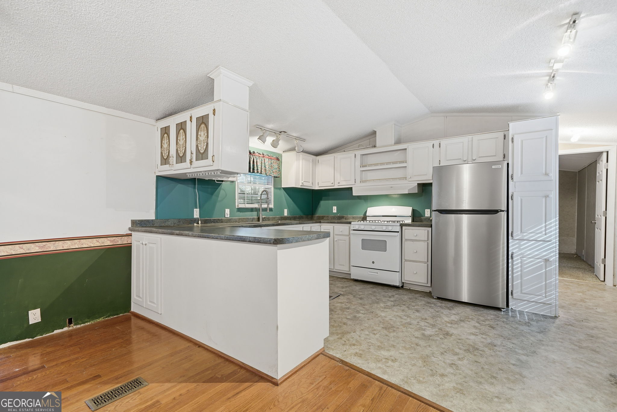 1907 John Call Road Ellijay, GA 30536 - Photo 25 of 41 a kitchen with white cabinets and stainless steel appliances