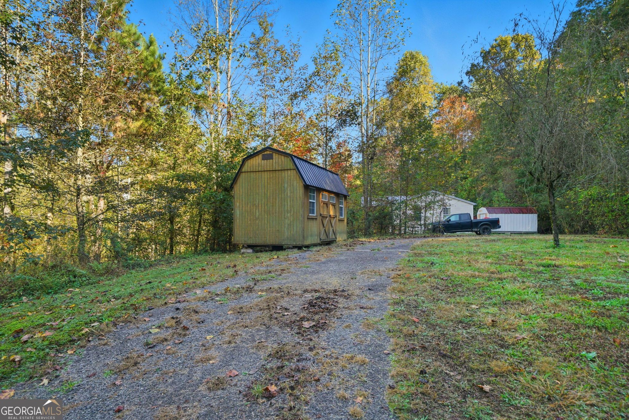 1907 John Call Road Ellijay, GA 30536 - Photo 8 of 41 a backyard of a house with a garden and outdoor seating
