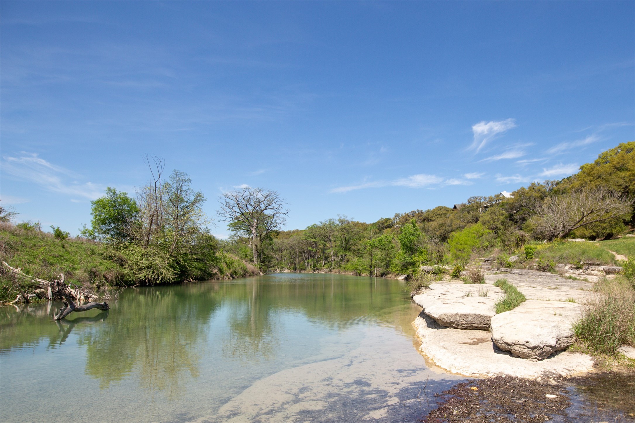 308 Ridge Oak Drive Wimberley, TX 78676 - Photo 6 of 29 a view of a lake with a yard