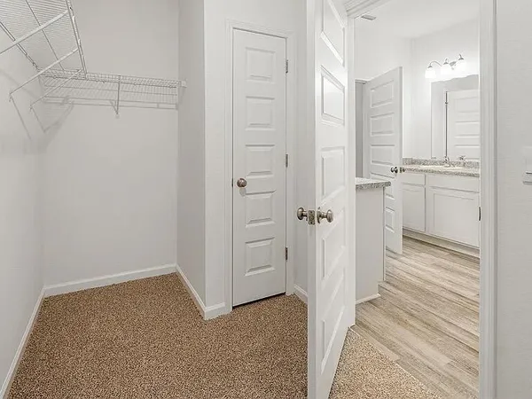 a view of a hallway with closet and cabinet