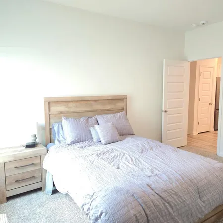 a bedroom with a bed and a dresser