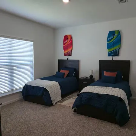 a bedroom with two beds and painting on the wall