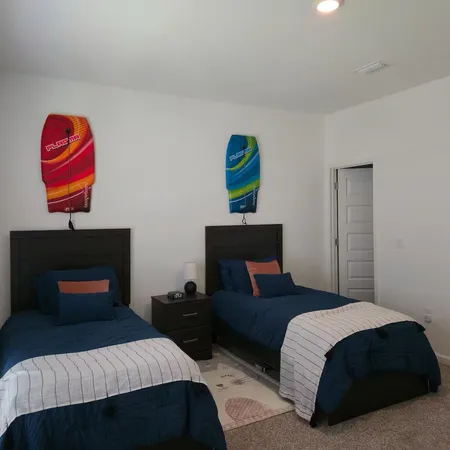 a bedroom with a bed and a lamp on dresser