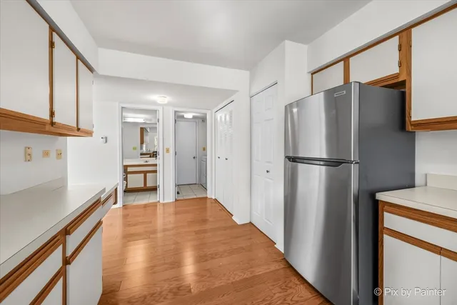 a kitchen with stainless steel appliances a refrigerator and a stove top oven