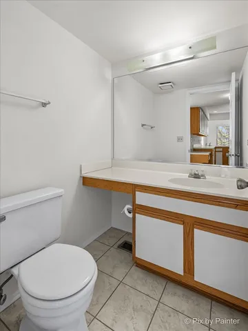 a bathroom with a sink a toilet a vanity and mirror