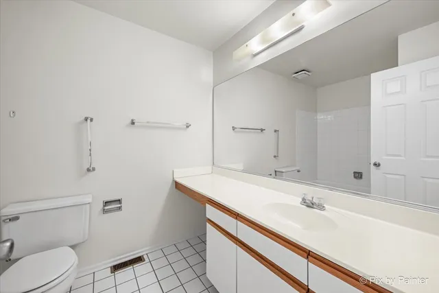 a bathroom with a sink toilet vanity and tub