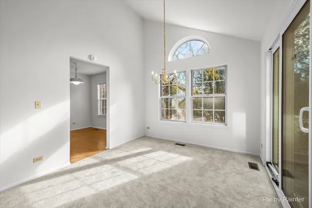 an empty room with fan and windows