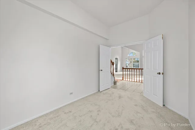 a view of a hallway with a bedroom and door