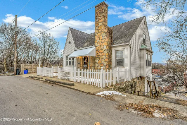a view of a house with a yard and garage